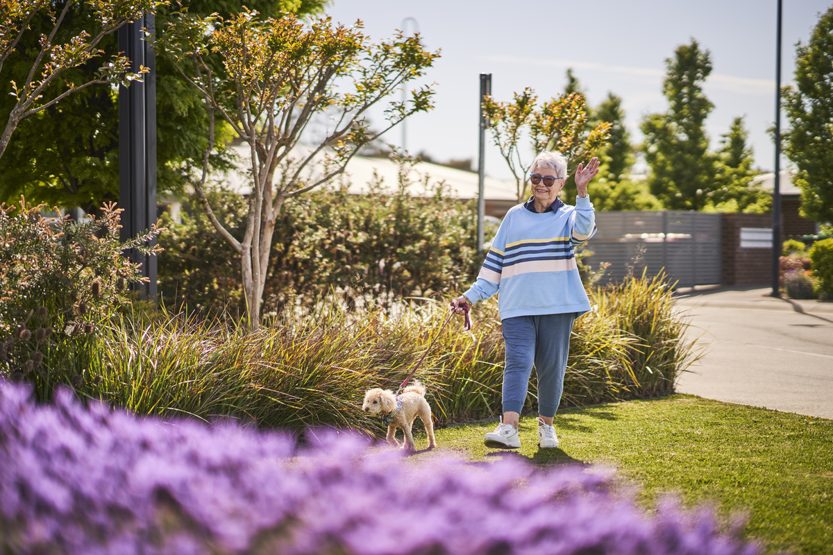 The Grove Ngunnawal Lifestyle - Resident walking with pet in the garden