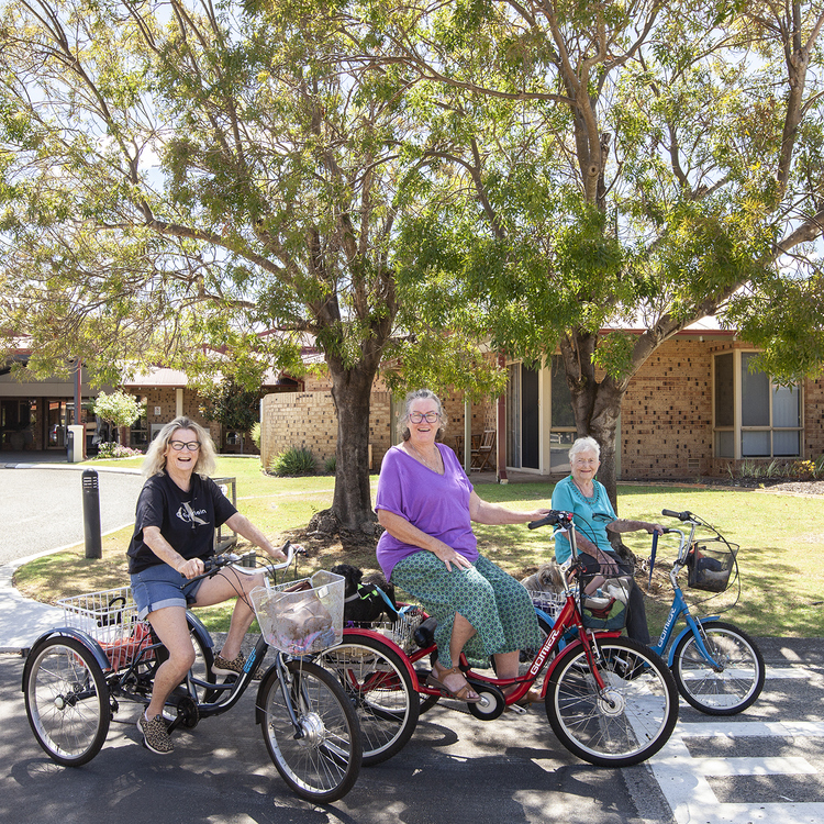 Ann, Maggie and Winnie cruise around Lakeside Village on their trikes.