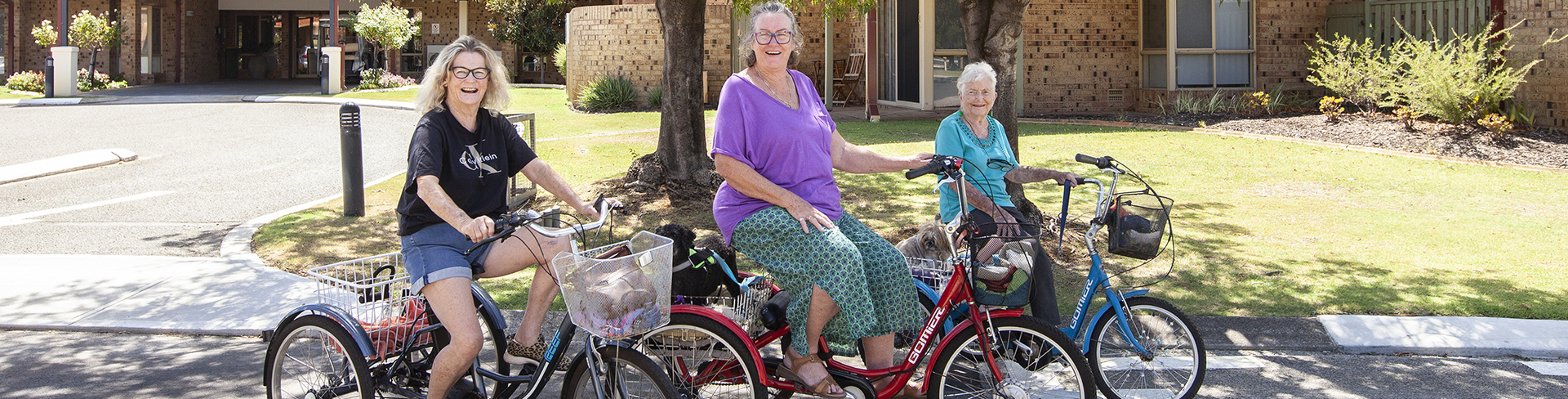 Ann, Maggie and Winnie cruise around Lakeside Village on their trikes.