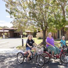 Ann, Maggie and Winnie cruise around Lakeside Village on their trikes.