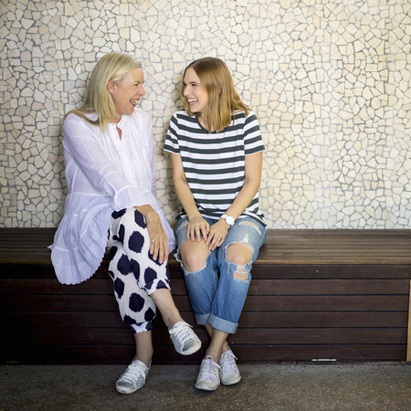 Older and younger woman laughing together