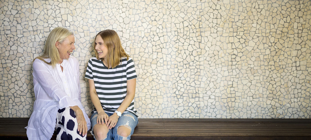 Older and younger woman laughing together