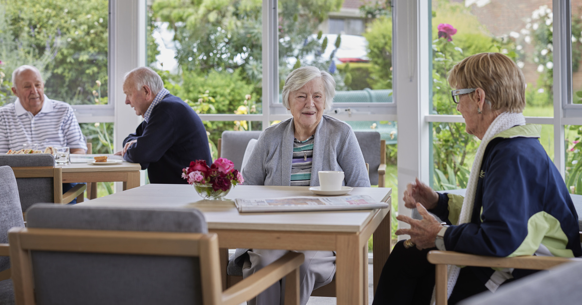 A group of residents sitting and enjoying a chat in the community centre at Viewbank Gardens in Victoria. 