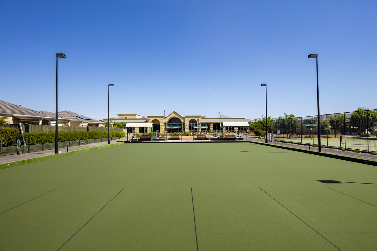Waterford Valley Lakes bowling green with night lights, shade and seating, green located next to main building and tennis court