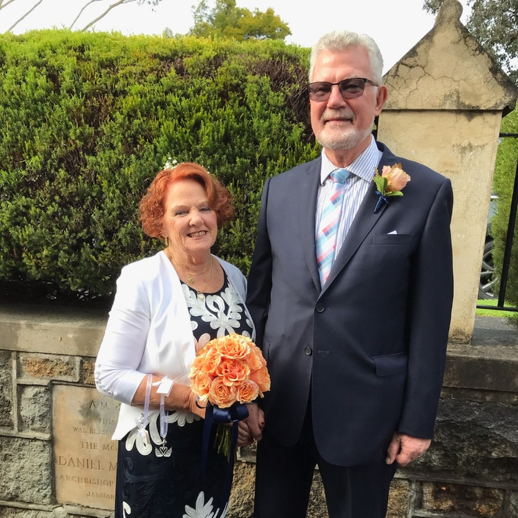 a senior couple posing on their wedding day