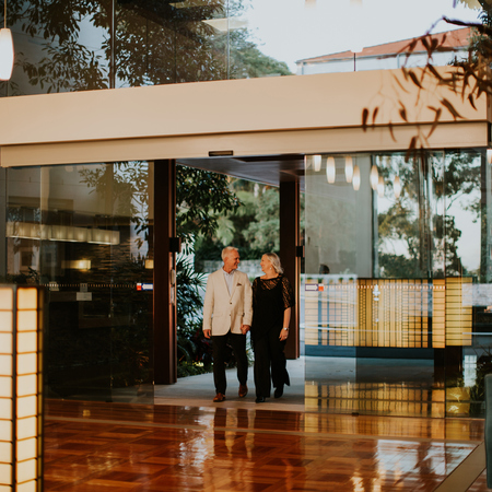 Senior couple entering to the reception area