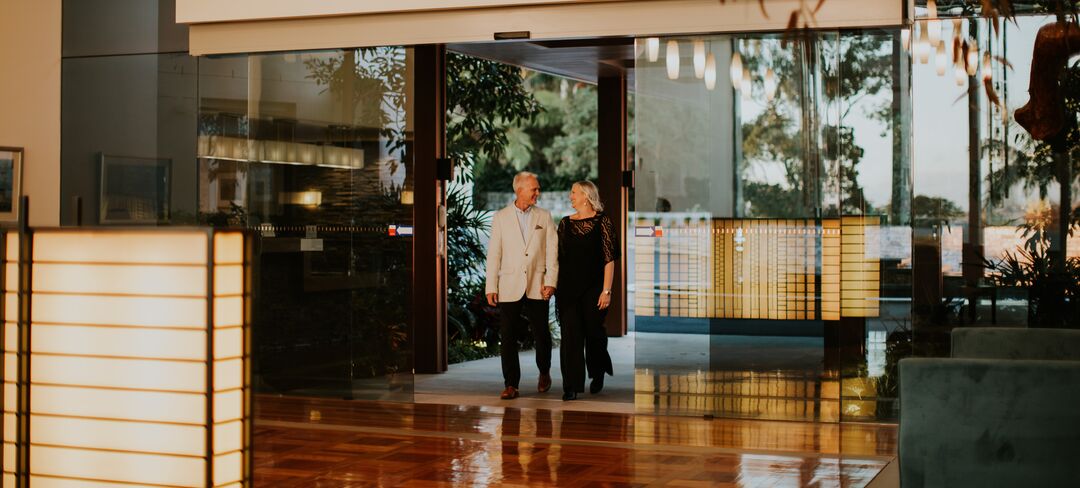 Senior couple entering to the reception area
