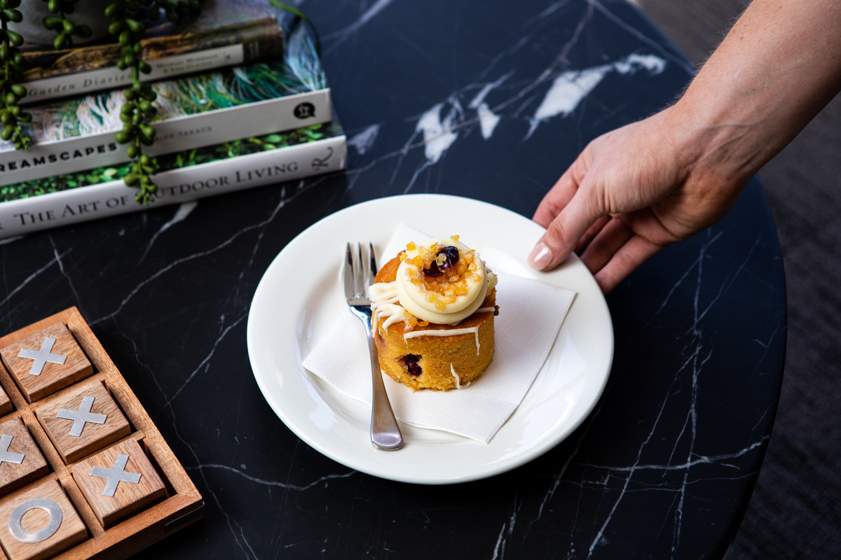 A delicious little cake on a plate with a fork