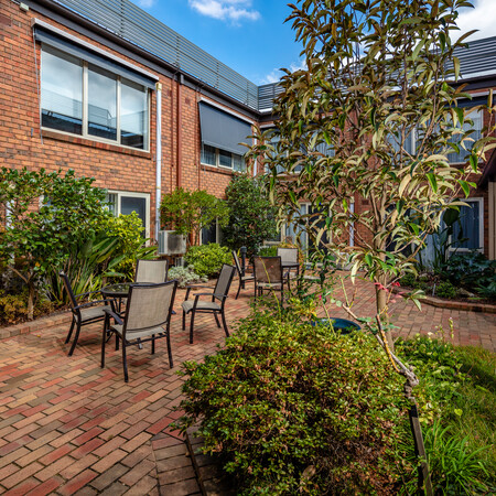 Highvale Village courtyard amongst building with courtyard garden, table and chairs