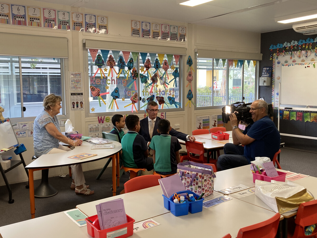 Mike Dalton from Channel 9 News interviews the students from the intergenerational reading program in their school in Ropes Crossing