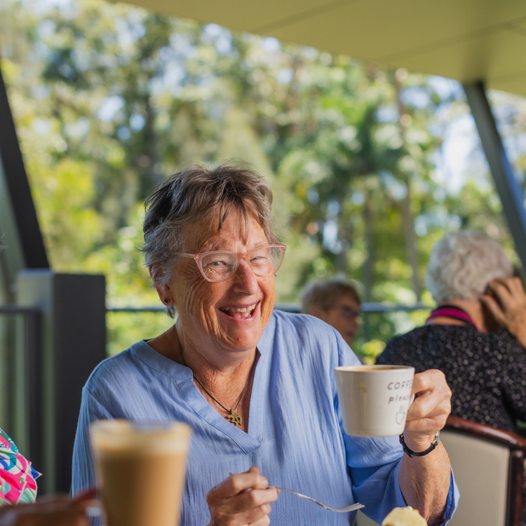 A senior citizen smiling at the camera 