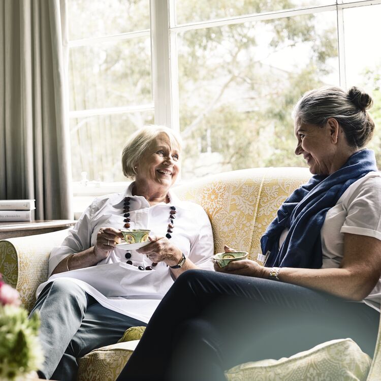 Two women sitting having tea