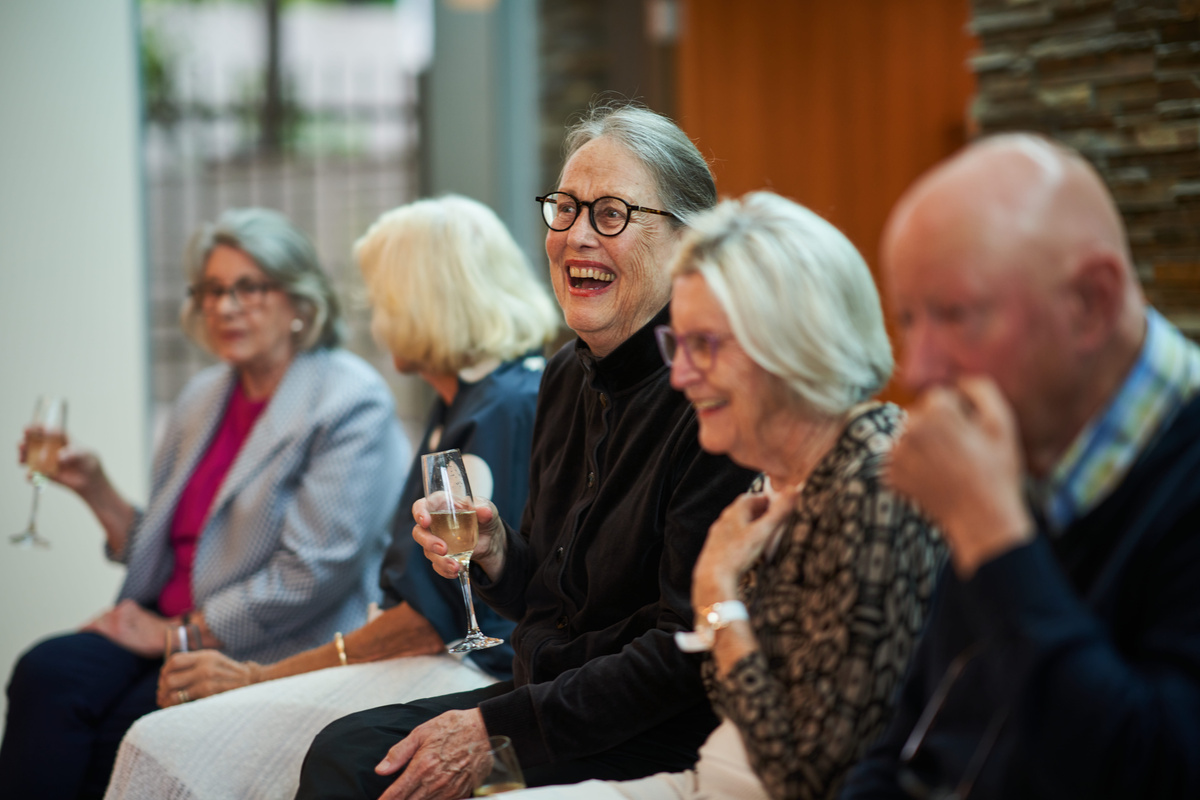 Residents enjoying a glass of champagne at the grand opening