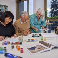 Smiling Residents in an art class