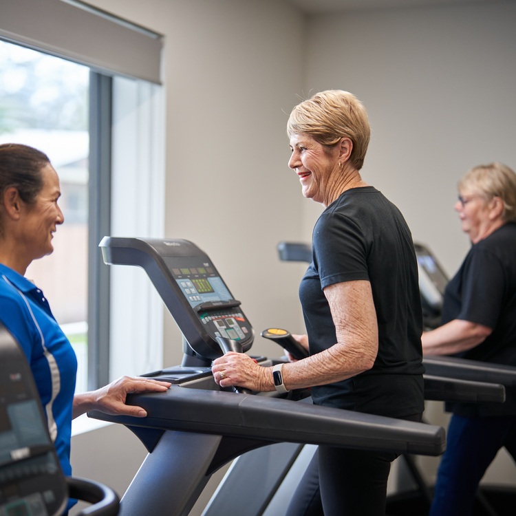 Brentwood Village fireplace sourrounded by comfortable seating and dining area in background