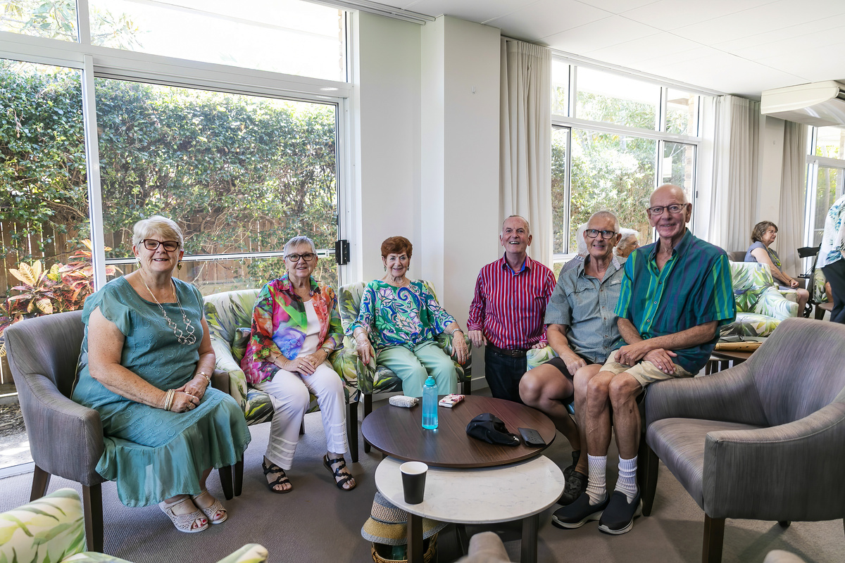 Residents of the village sitting and chatting in the community centre