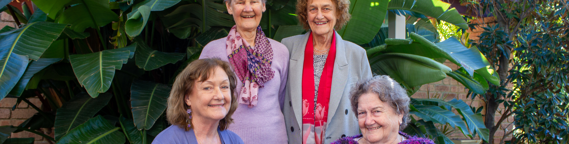 Sisters Bernie Taylor, Claire Pope, Mary Martin and Ann Freeman-Smith are gathered together, smiling in the lush surroundings of Parkland Villas Booragoon.
