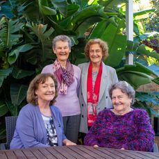 Sisters Bernie Taylor, Claire Pope, Mary Martin and Ann Freeman-Smith are gathered together, smiling in the lush surroundings of Parkland Villas Booragoon.