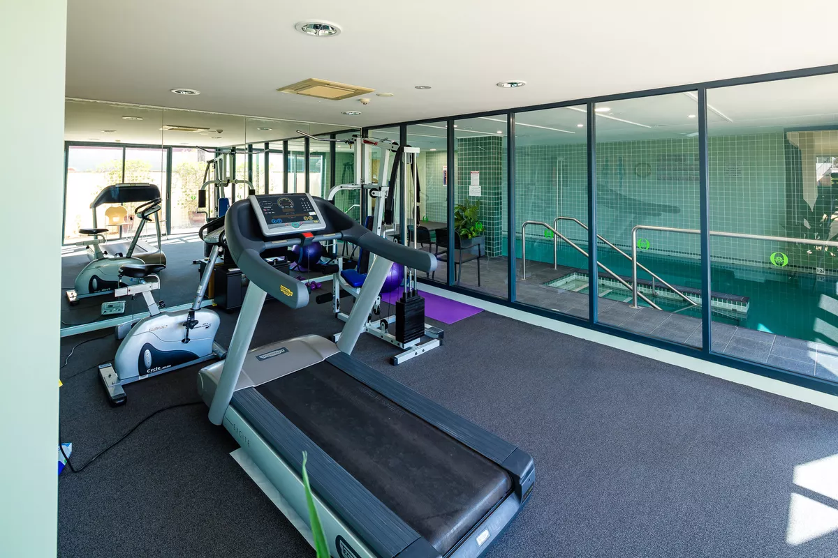 Nelsons Grove Village Gym showing a treadmill, weights and bicycle