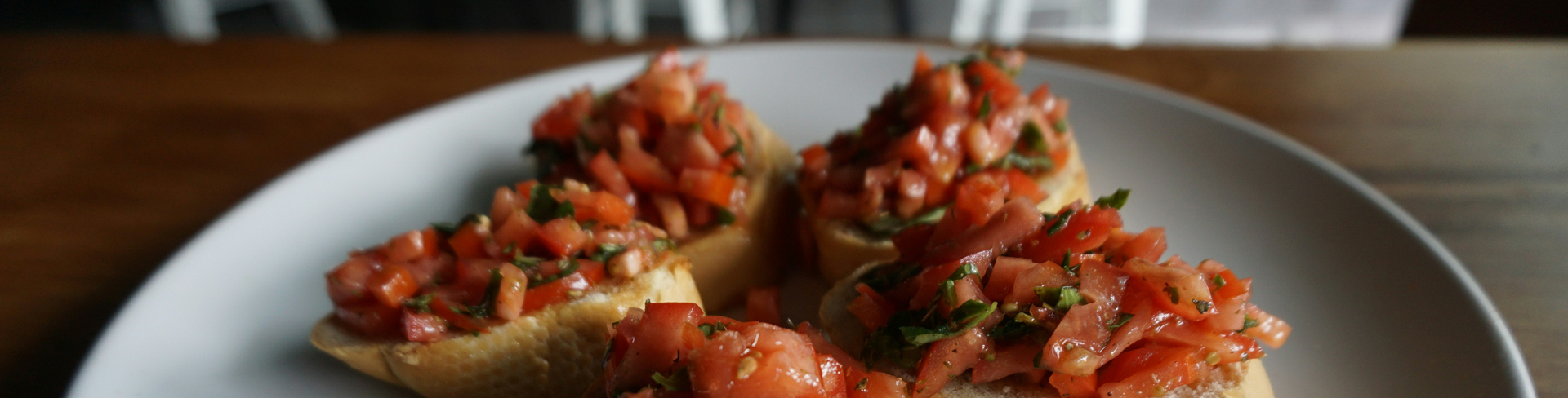 Four slices of bruschetta on a round plate