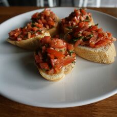 Four slices of bruschetta on a round plate