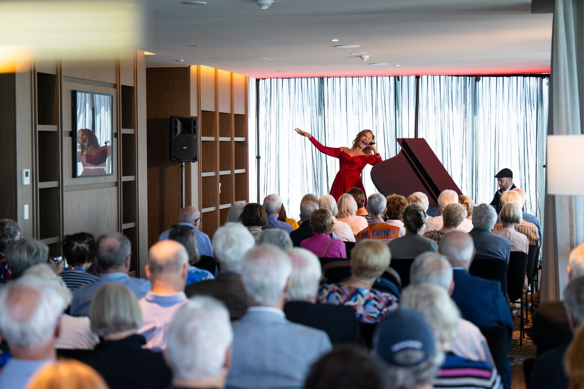 Rhonda Burchmore performing for residents in the Kennedy Club at Ardency Kennedy Place