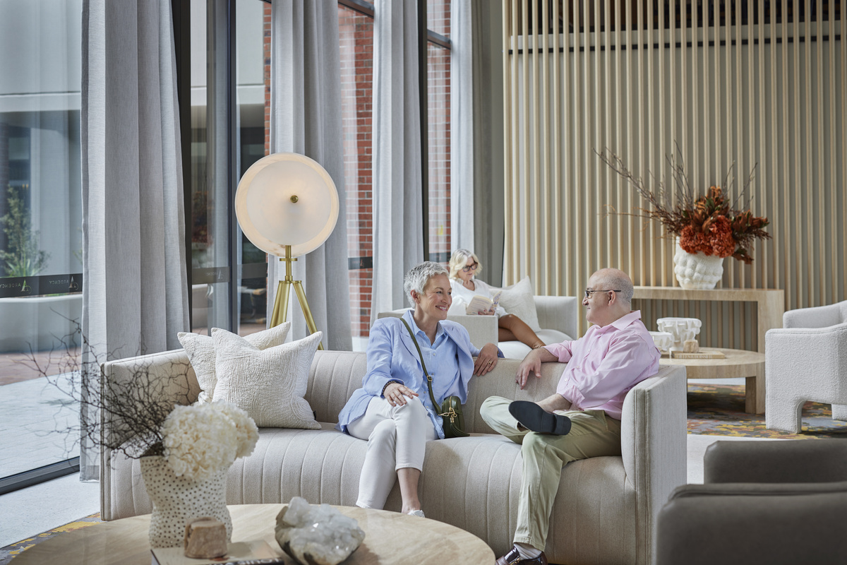 Senior pair conversing in a luxury lounge
