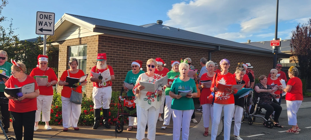 Choir members from The Grove singing Christmas Carols
