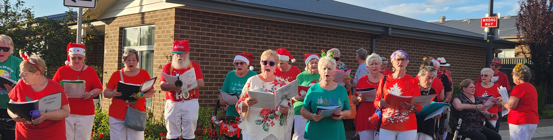 Choir members from The Grove singing Christmas Carols