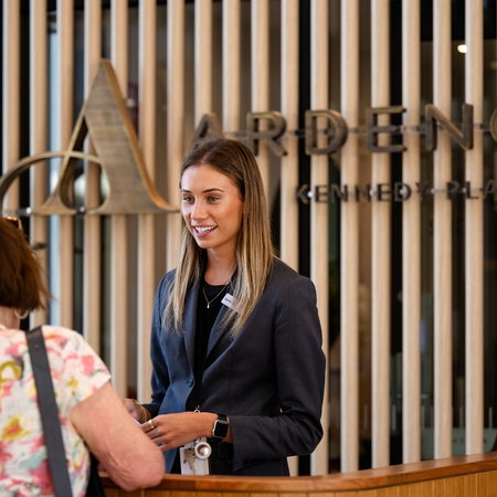 Jamieson smiling and talking to a resident at the Ardency Kennedy Place