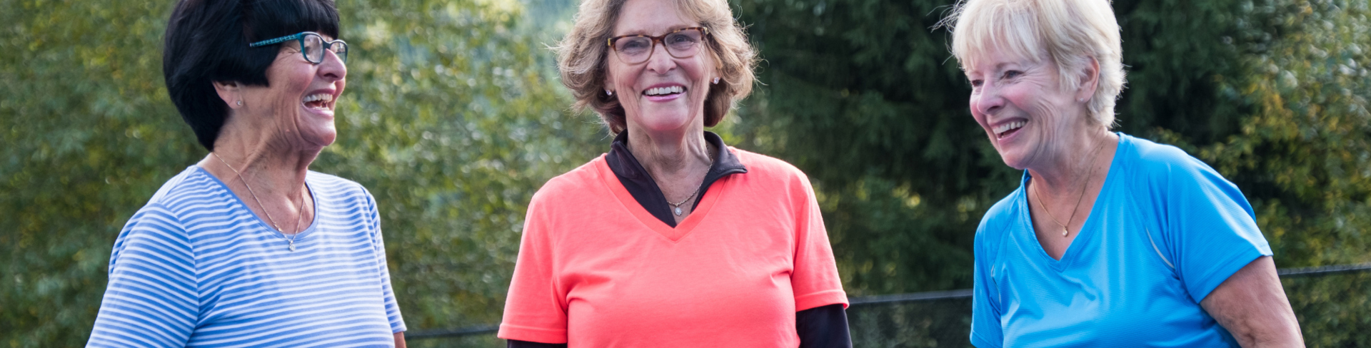 3 ladies playing Pickleball and smiling