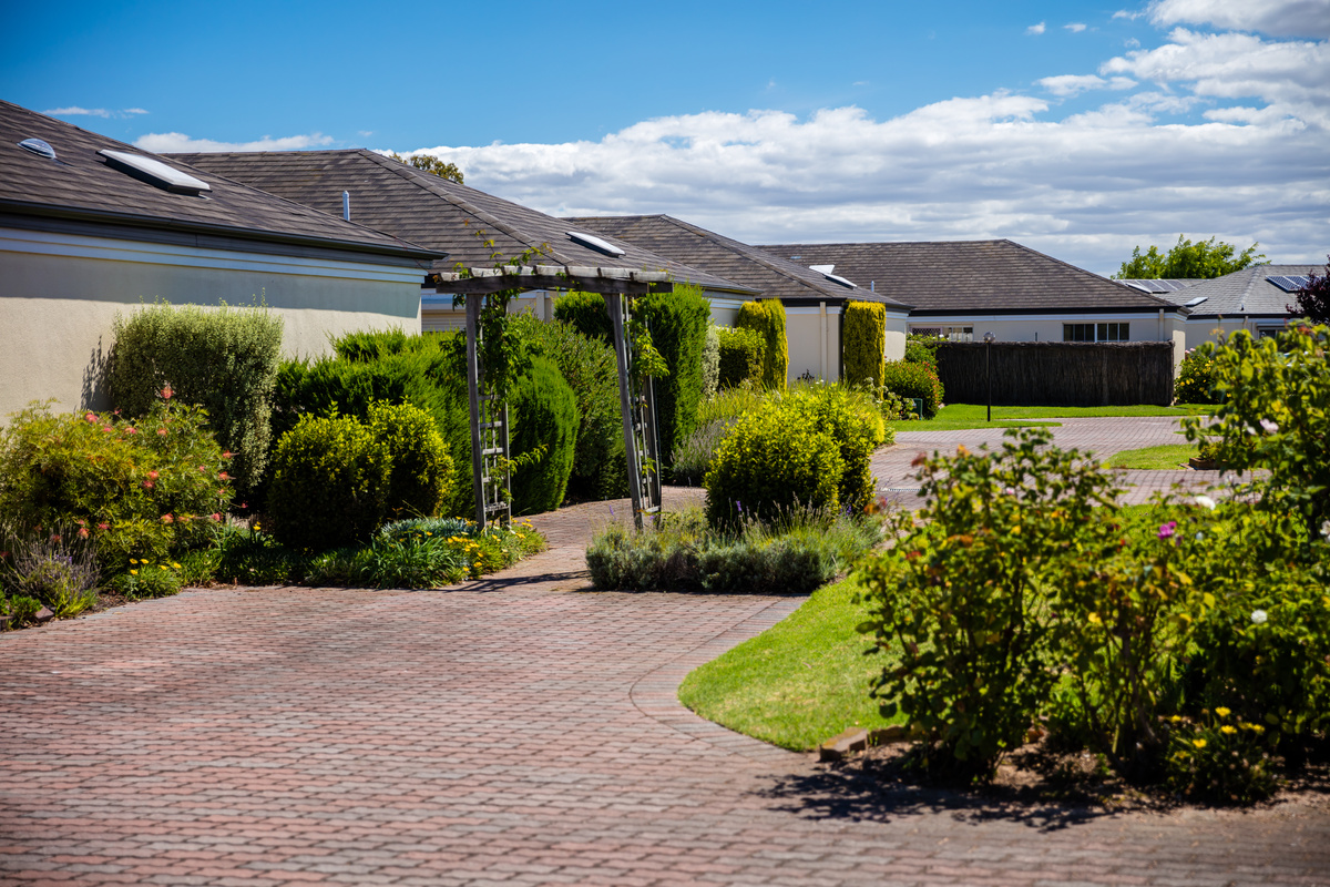 Port Phillip Village street view of road, path, garden and houses