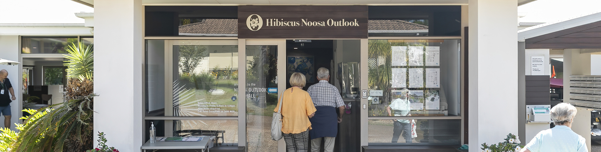 Two seniors walking into the community centre at Hibiscus Noosa Outlook