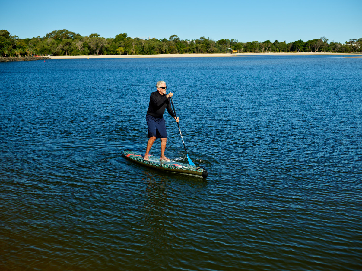 Man paddleboarding Noosa Spit at Sunshine Coast Queensland
