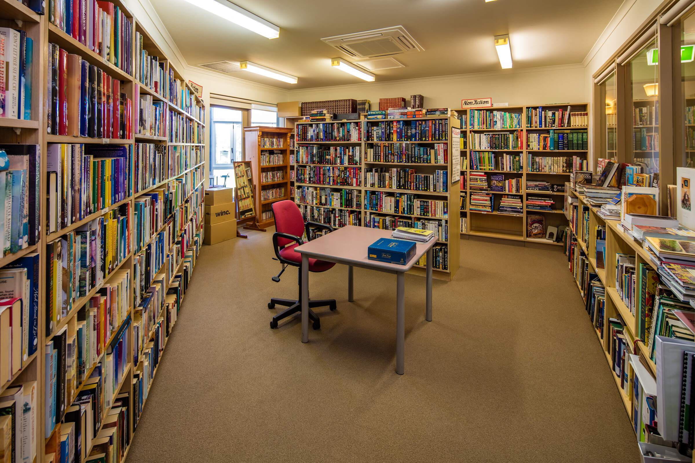 Peppertree Hill library room with well stocked bookcases desk and seating