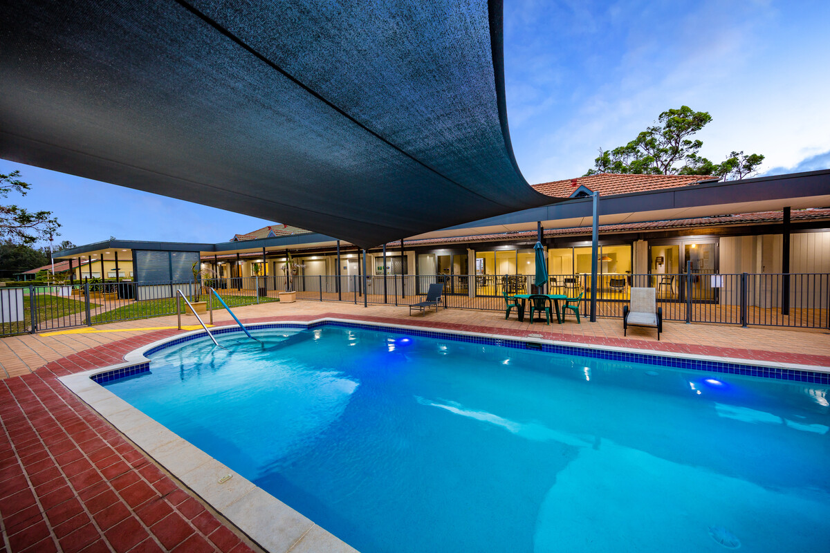BONV - Lakeside Retirement Village Outdoor Swimming Pool in the evening, showing a shade over the pool