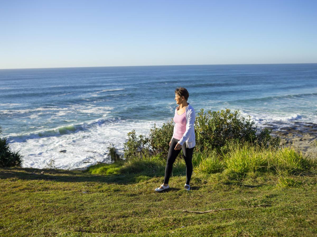 A senior woman walking near the beach
