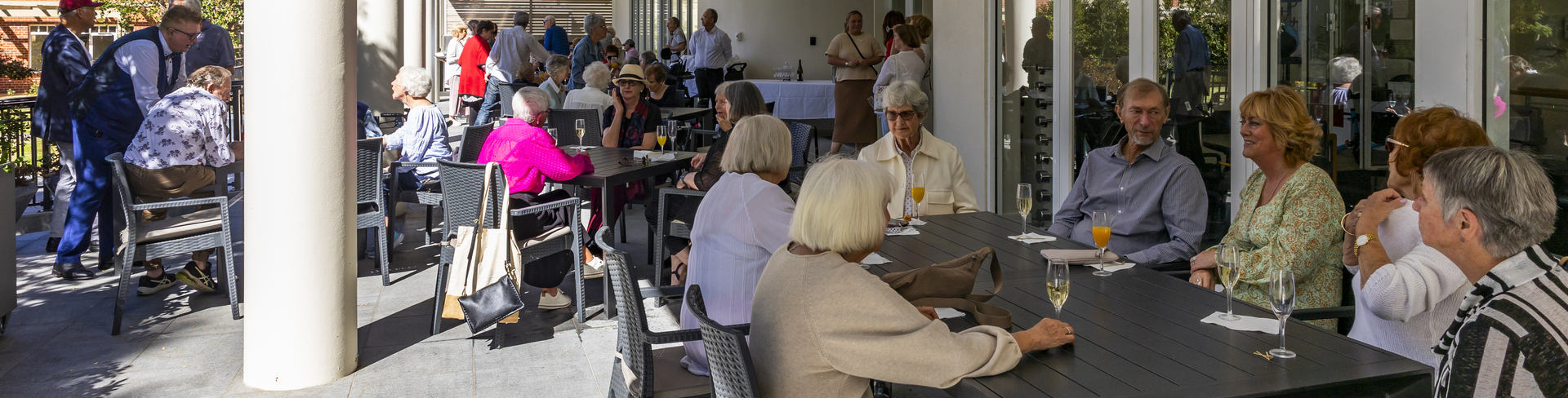 An elderly lady laughing to the camera at an event