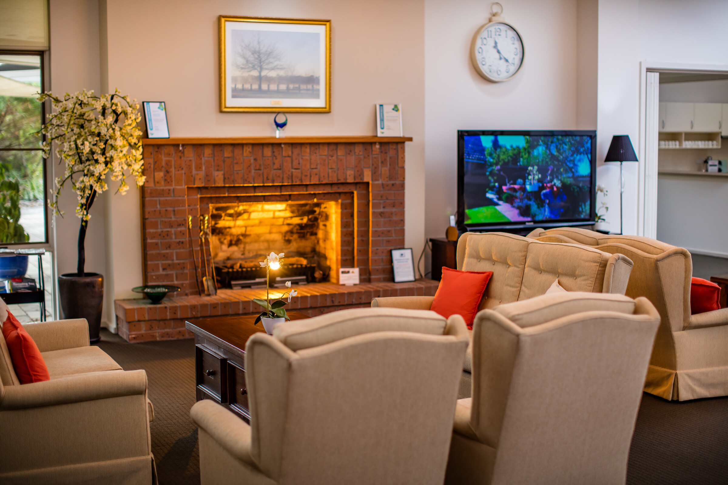 Highvale Village fireplace with seating and television