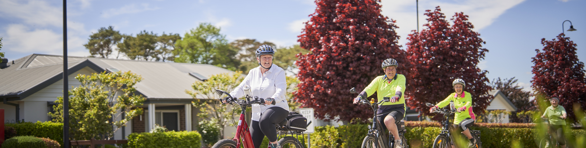 A group of seniors cycling in the retirement village