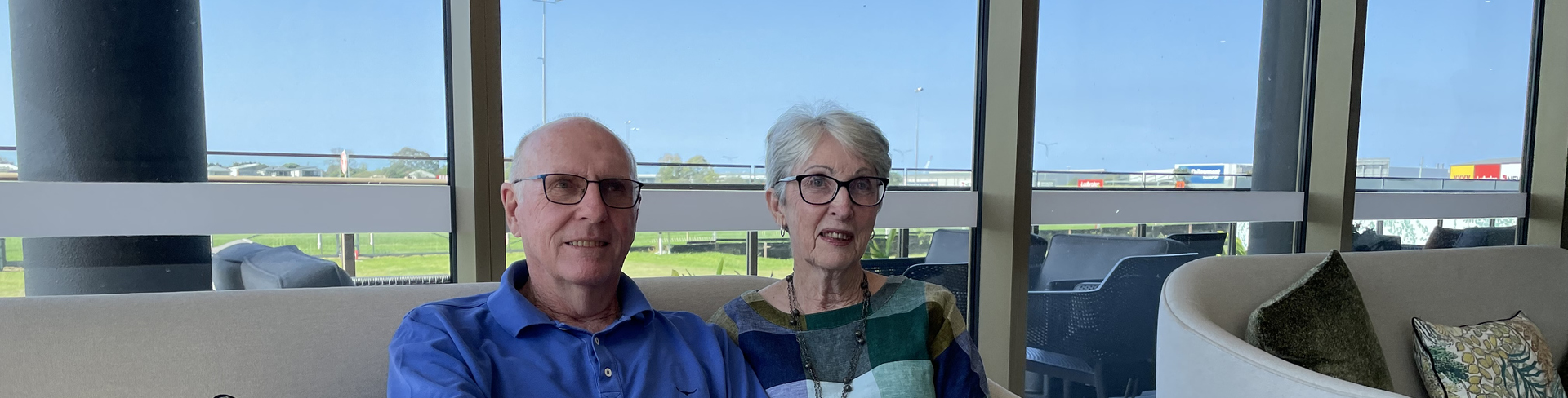 Bernborough Ascot residents Janis and Peter sitting on a couch