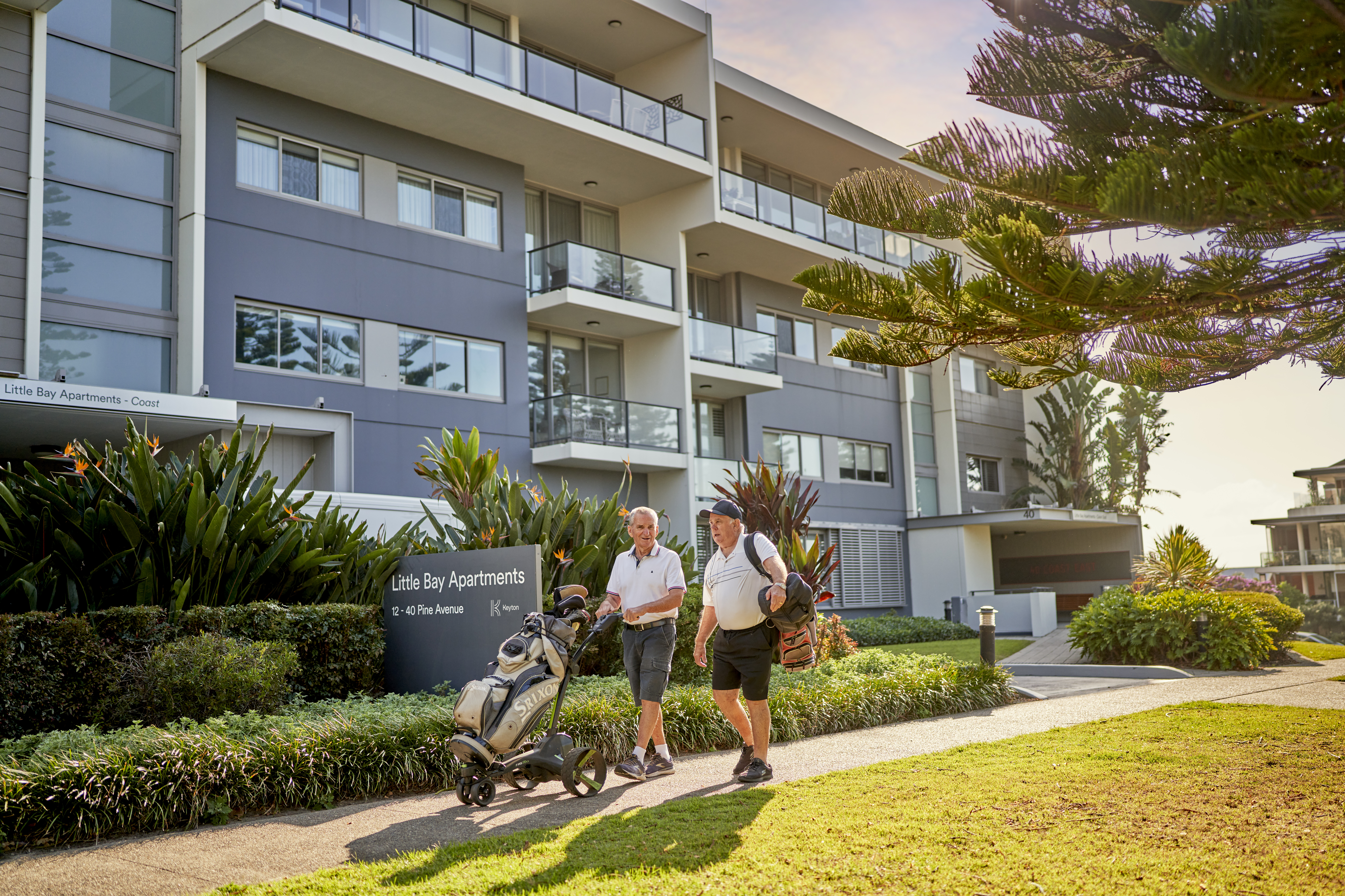 Little Bay Apartments Hero Front shot lifestyle with Golf Residents 