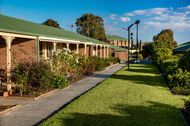 Meadowvale Village path outside houses with gardens and lawns and solar lamp posts