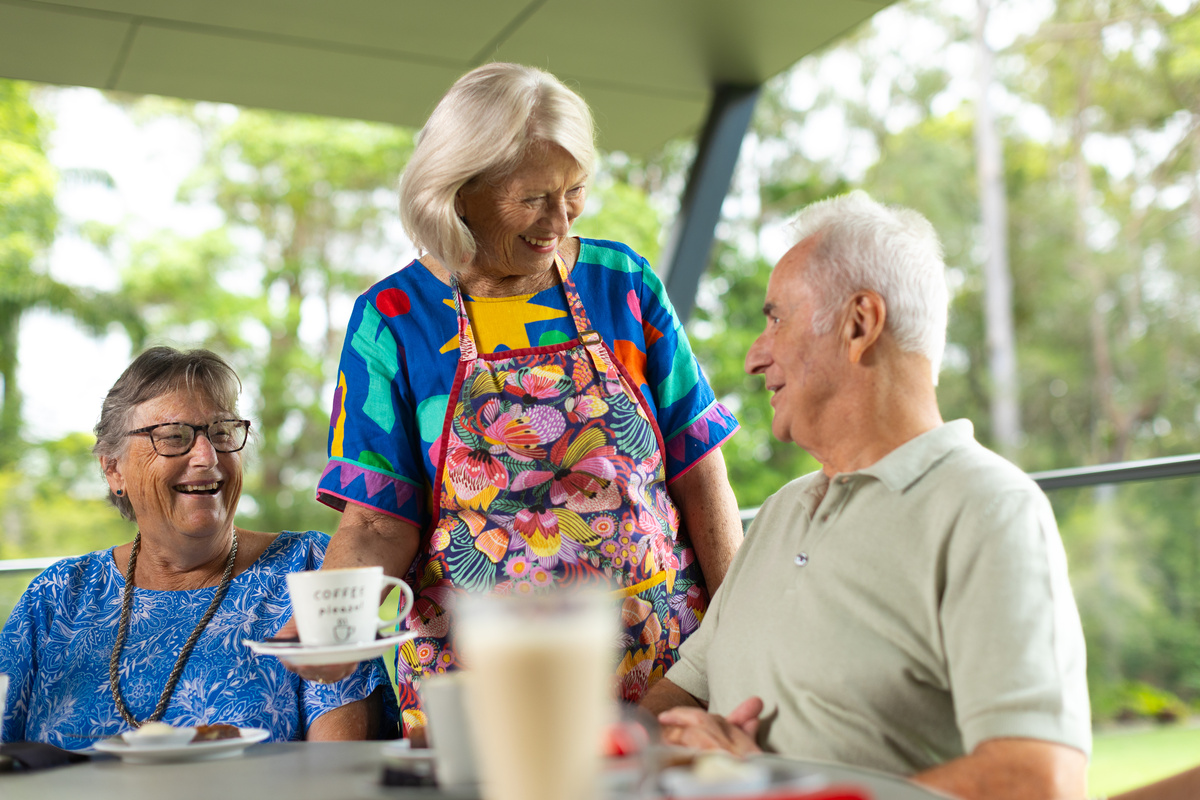Susan serving residents at Rumours Café