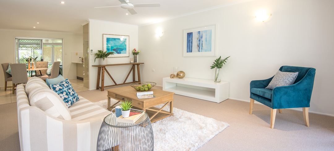 An open space living area in a theme of white and blue