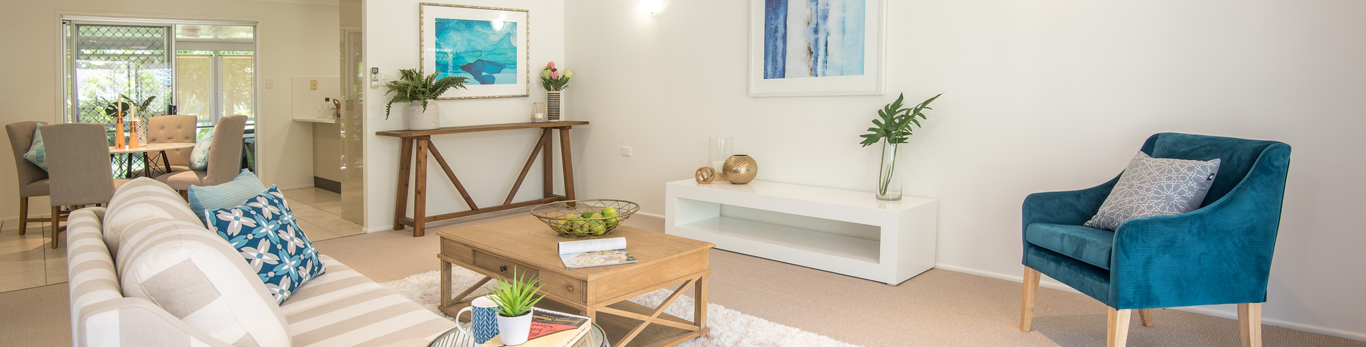 An open space living area in a theme of white and blue