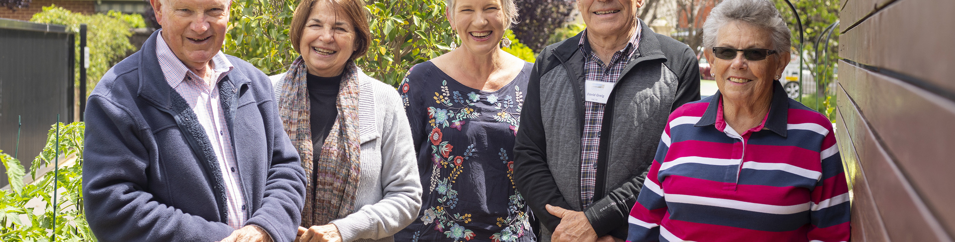 Five elderly members of the retirement village gardening group The Mad Potters pose in their garden 