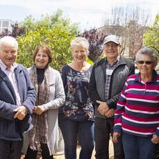 Five elderly members of the retirement village gardening group The Mad Potters pose in their garden 
