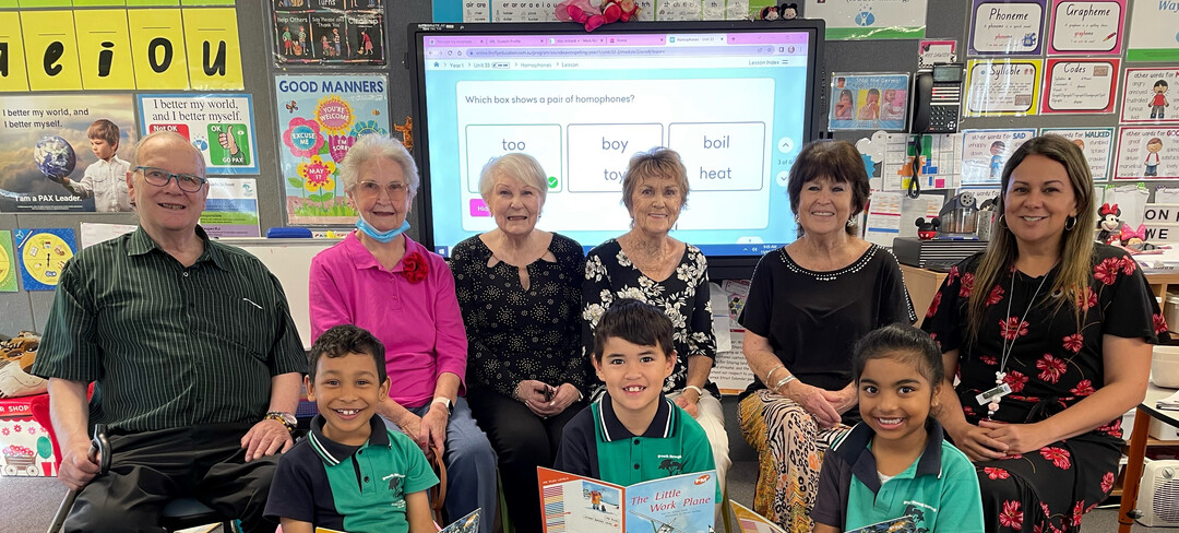 Residents from the Rochford place retirement village pose for a group photo with students from their intergenerational reading program