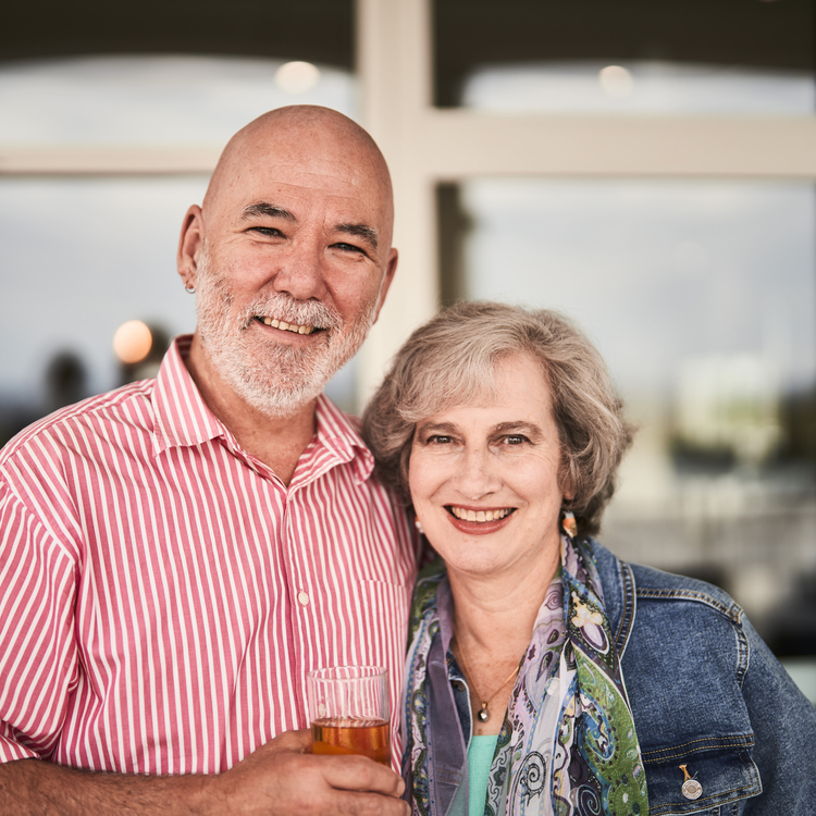 A couple looking at the camera and smiling